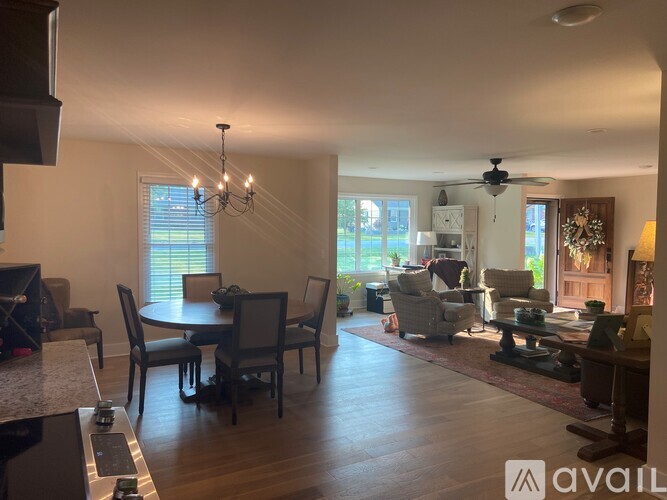 A living room with a dining table and chairs.