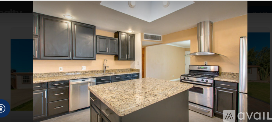 A kitchen with granite countertops and stainless steel appliances.