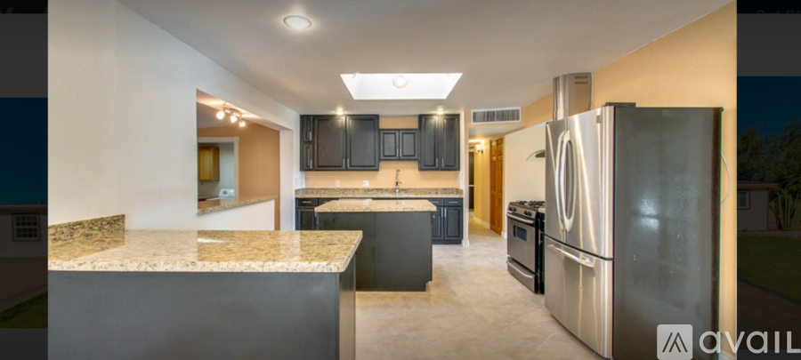 A kitchen with granite countertops and stainless steel appliances is available for rent.
