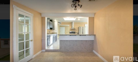 A kitchen area with a counter and a refrigerator.