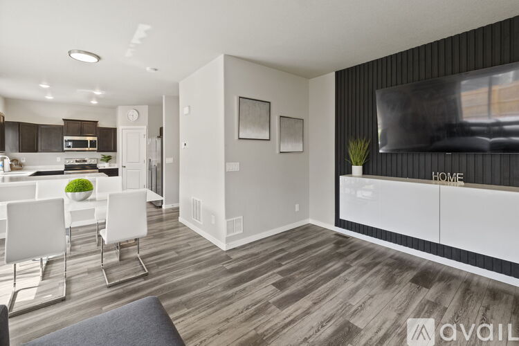 A modern living room with a white dining table and chairs.