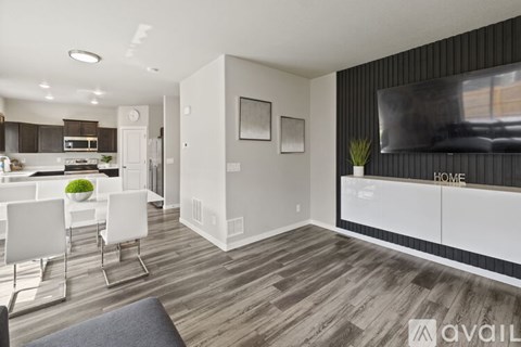 A modern living room with a white dining table and chairs.
