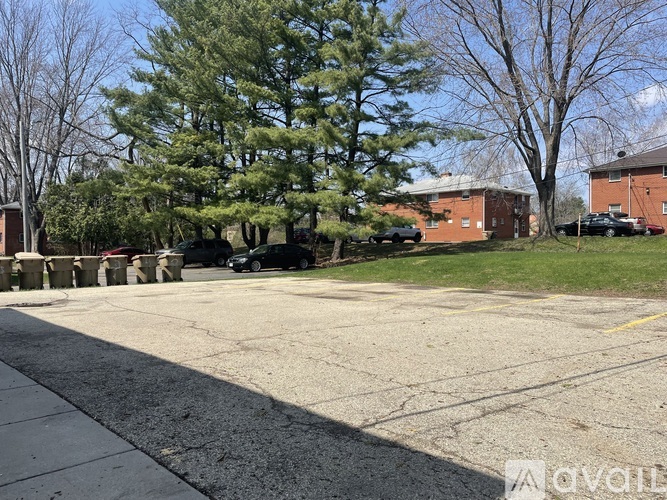 A parking lot with a car and a truck parked in front of a building.