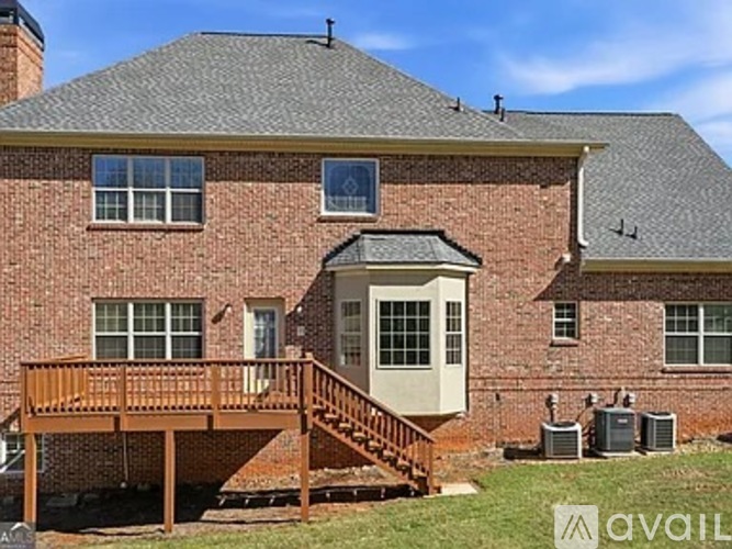 A brick house with a deck and a small entrance.