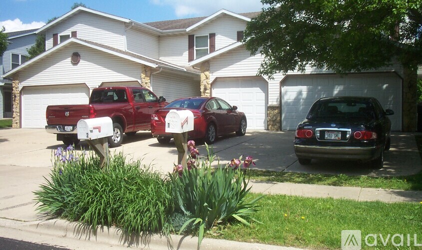 A red truck is parked in front of a house.