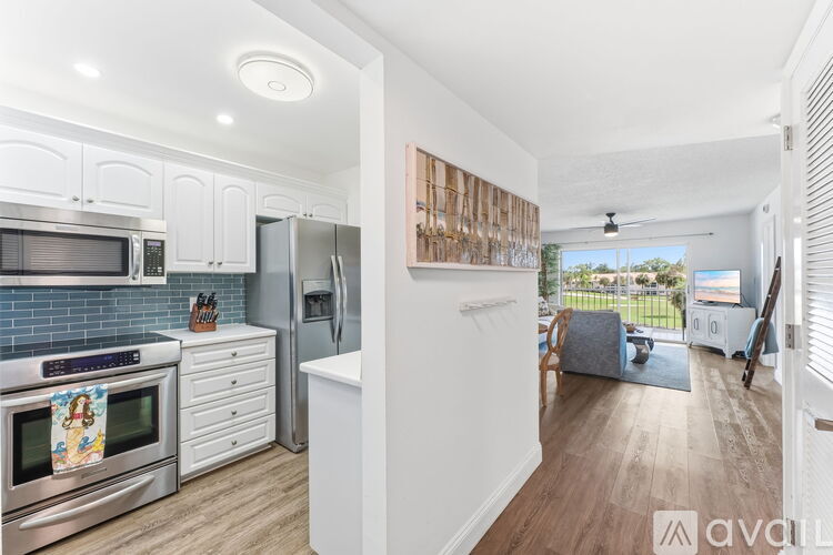 A kitchen with white cabinets and a stainless steel oven.
