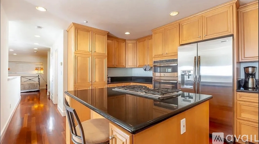 A kitchen with wooden cabinets and a black countertop.