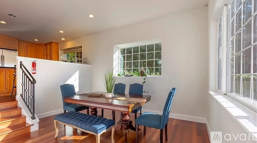 A dining room with a table and chairs.