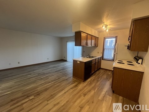 A kitchen with wooden floors and cabinets is available for rent.