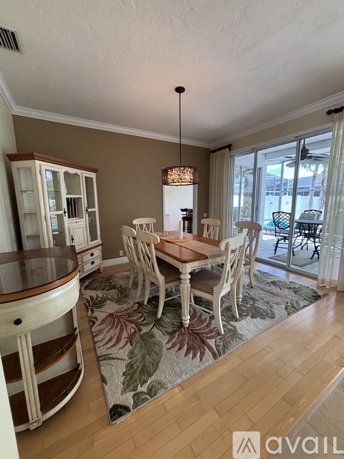 A dining room with a wooden table and chairs.