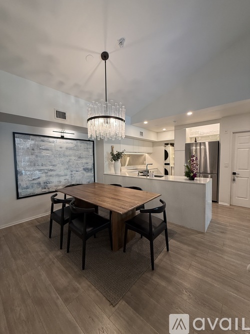 A modern dining room with a wooden table and chairs.