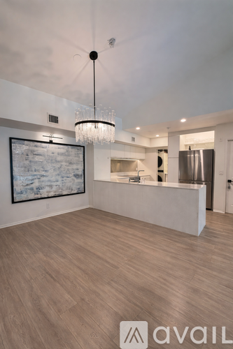 A modern kitchen with a wooden table and chairs.