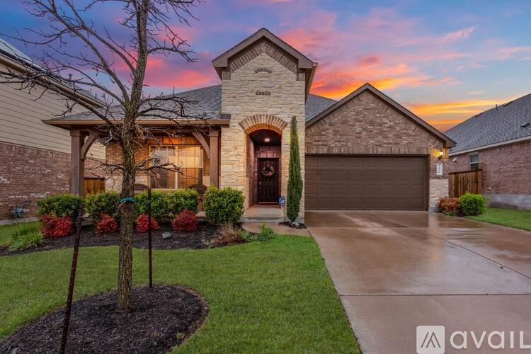 A house with a stone facade and a large front yard.