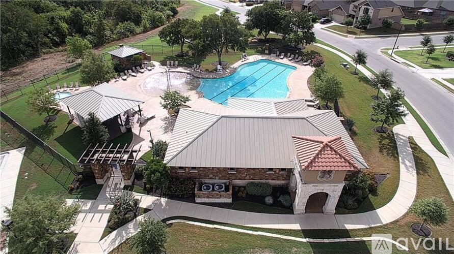 A bird's eye view of a house with a pool and a covered patio.