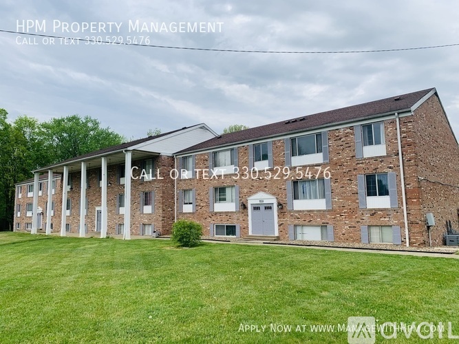 A brick building with a sign that says HPM Property Management.