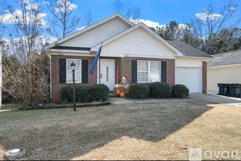 A house with a white garage door and a blue flag on the front porch.