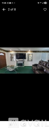 A living room with a couch and a television.