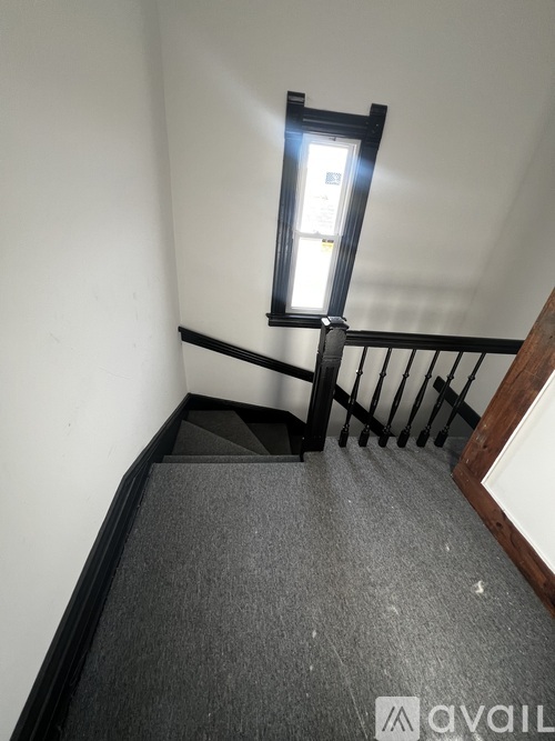 A staircase with a light on the side.