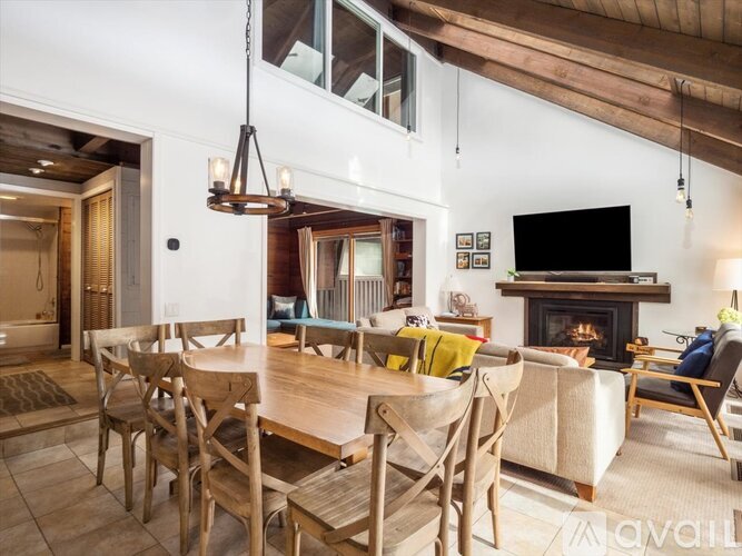 A modern dining room with a wooden table and chairs.