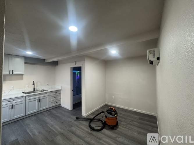 A room with a vacuum cleaner on the floor.