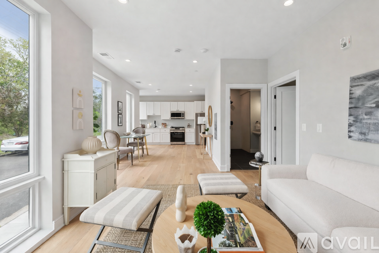 A modern living room with a white sofa and a coffee table.