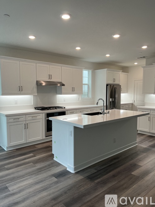A modern kitchen with a large island in the center.