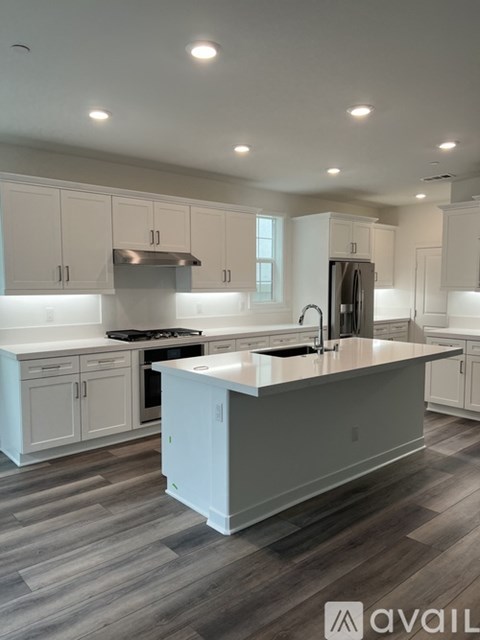 A modern kitchen with a large island in the center.