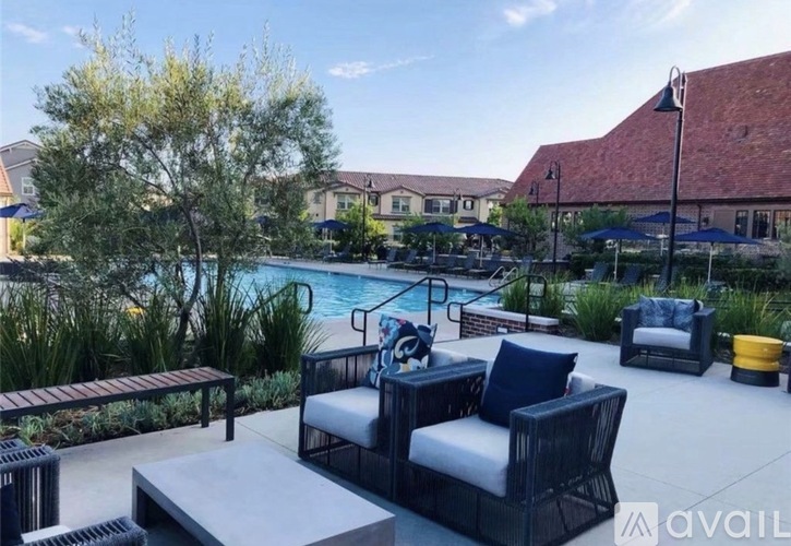 A poolside patio with a table and chairs.