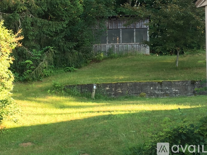 A grassy area with a building in the background.