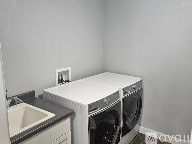 A white washing machine and dryer in a laundry room.