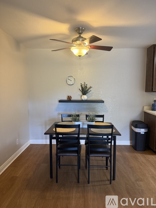 A dining room with a table and chairs.