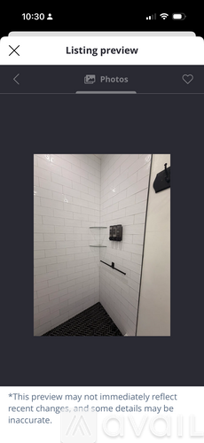 A small bathroom with a shower and a toilet.