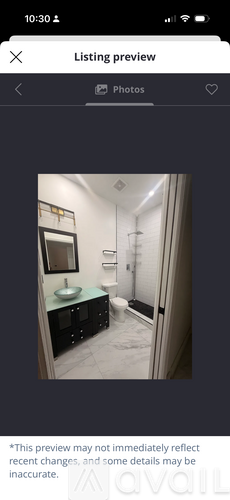 A bathroom with a sink, toilet, and a mirror.