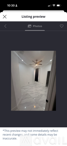 A room with a ceiling fan and a tiled floor.
