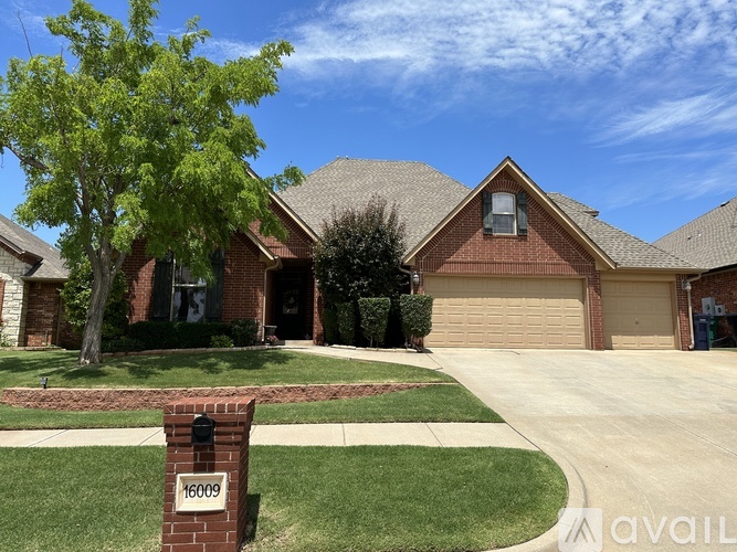 A house with a brick mailbox that says 16009 on it.