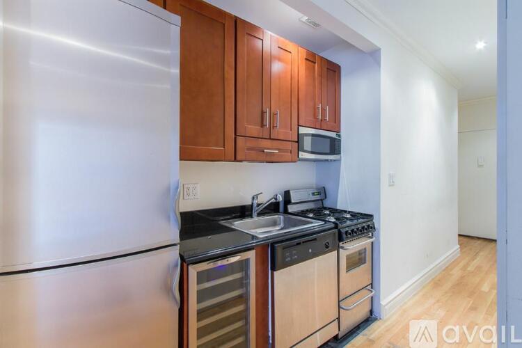 A kitchen with wooden cabinets and stainless steel appliances.