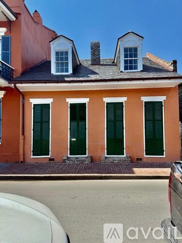 A red building with white trim and green doors.