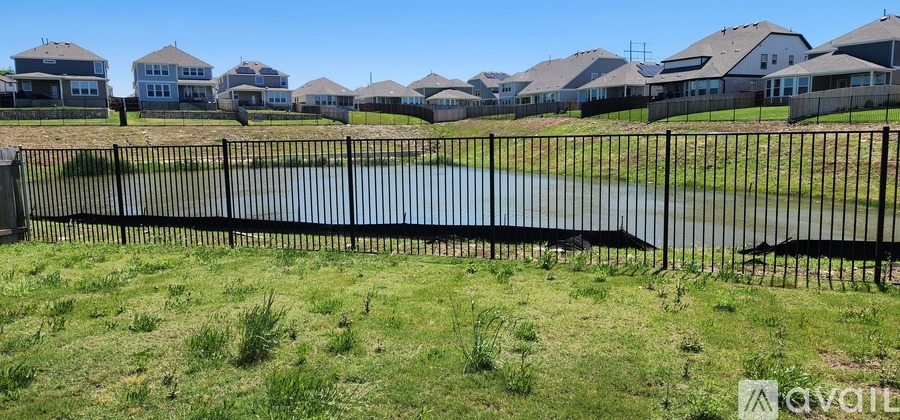 A row of houses with a black fence in front of them.