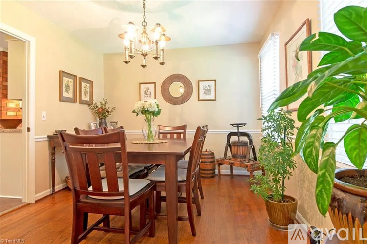 A dining room with a wooden table and chairs.