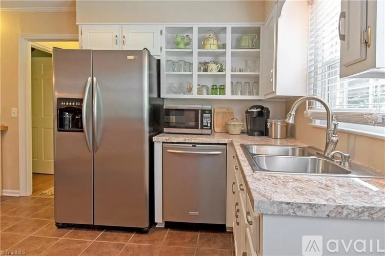 A kitchen with a stainless steel refrigerator and dishwasher.
