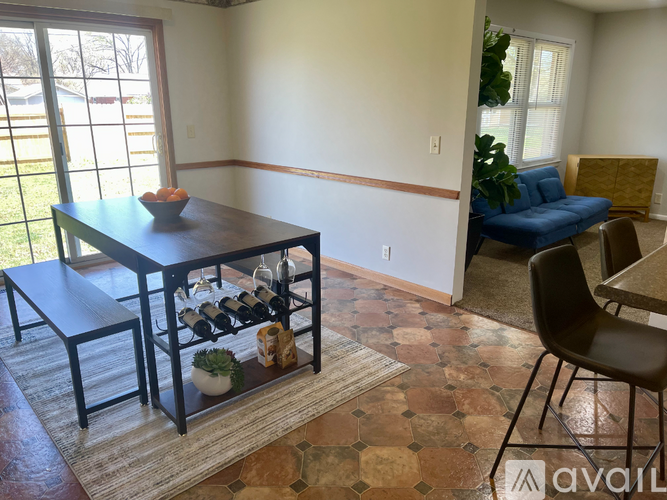 A dining room with a table and chairs.