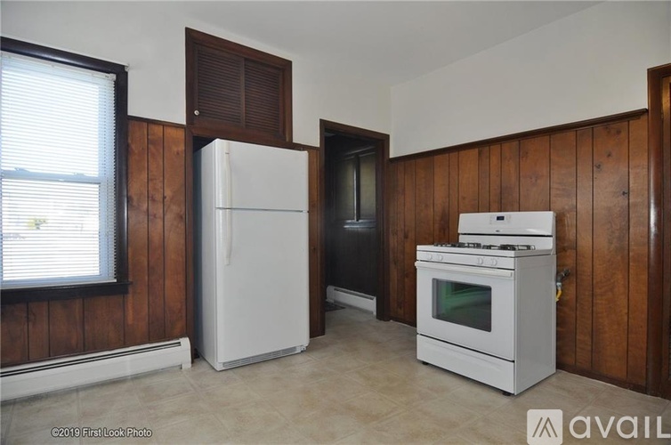 A kitchen with a white fridge, stove and oven.