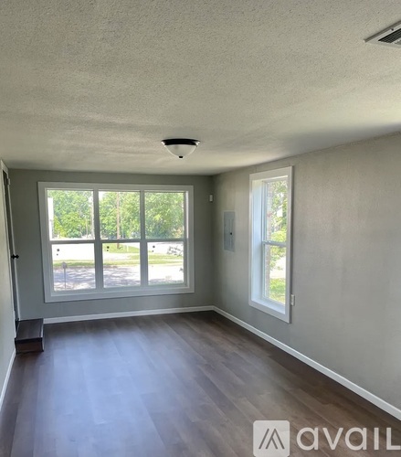 A room with a large window and a door.