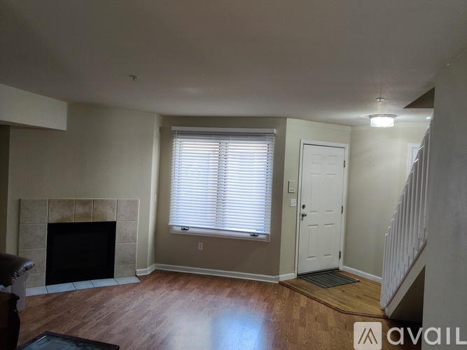 A living room with a fireplace and a door.