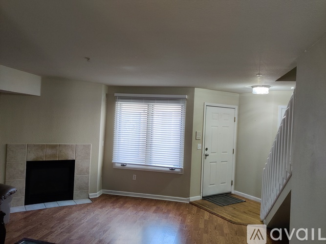 A living room with a fireplace and a door.
