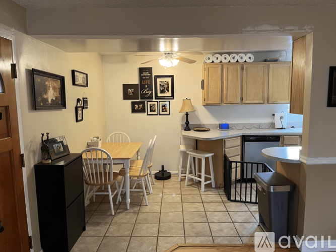 A kitchen with a table and chairs in the middle of the room.