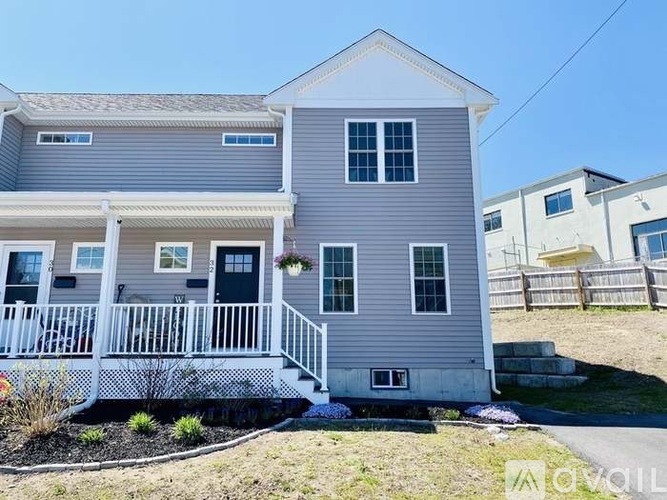 A two-story house with a grey exterior and white trim.