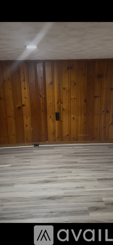 A room with wooden walls and a wooden floor.