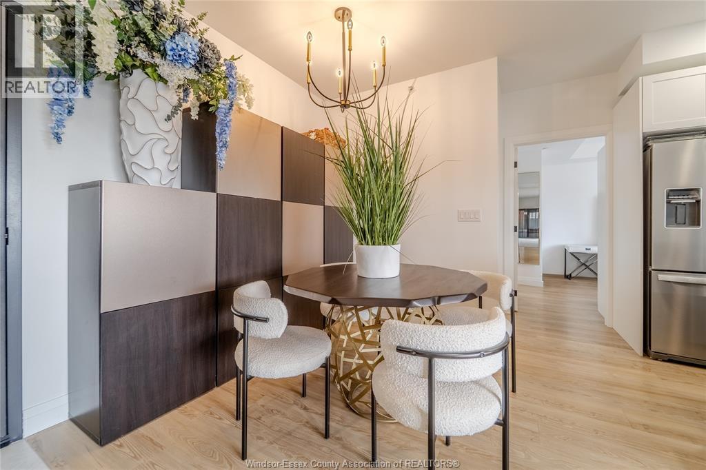 A dining area with a round table and chairs.