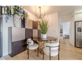 A dining area with a round table and chairs.